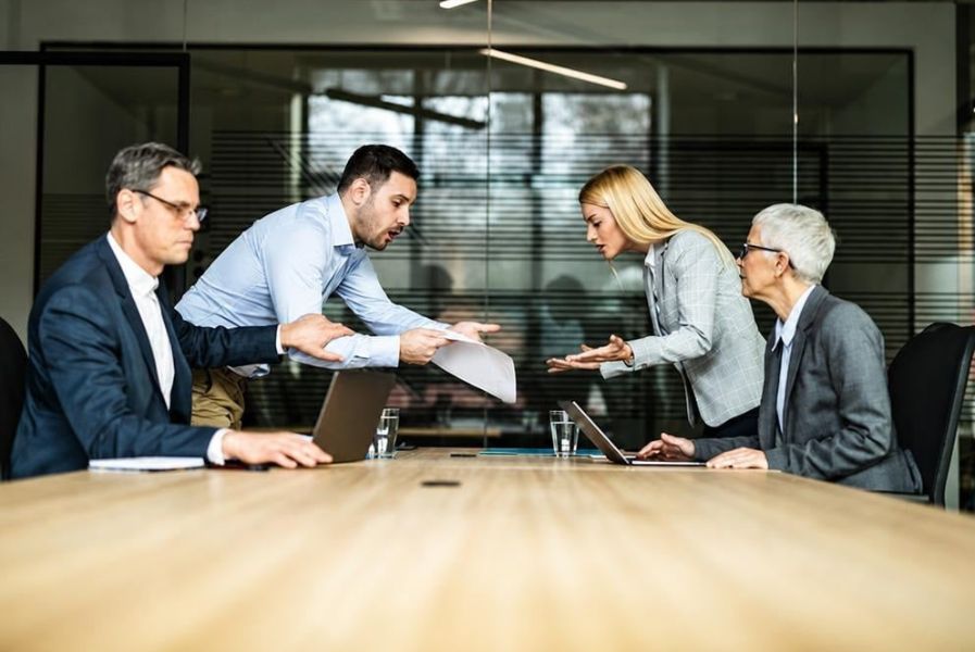 A divorcing couple reviews financial documents and settlement options during divorce mediation in Overland Park.