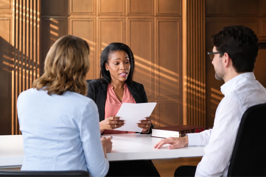 A family law attorney reviewing a proposed child custody and parenting schedule with a parent during divorce proceedings.